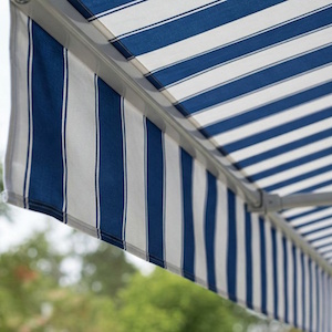 Retractable awning with new striped fabric replacement